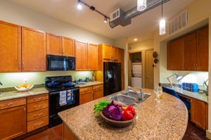 Two Bedroom Apartments for Rent in Houston, TX - Model Kitchen with Desk Nook, Double Sinks & Laundry Room View    